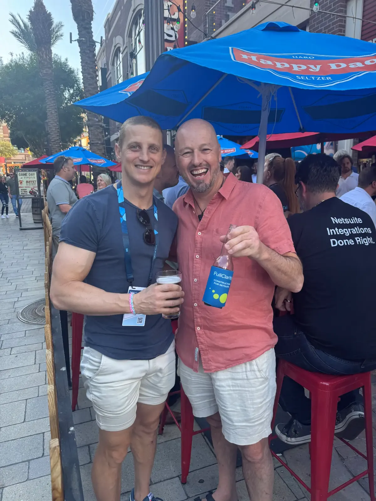 Two attendees with a FullClarity koozie
