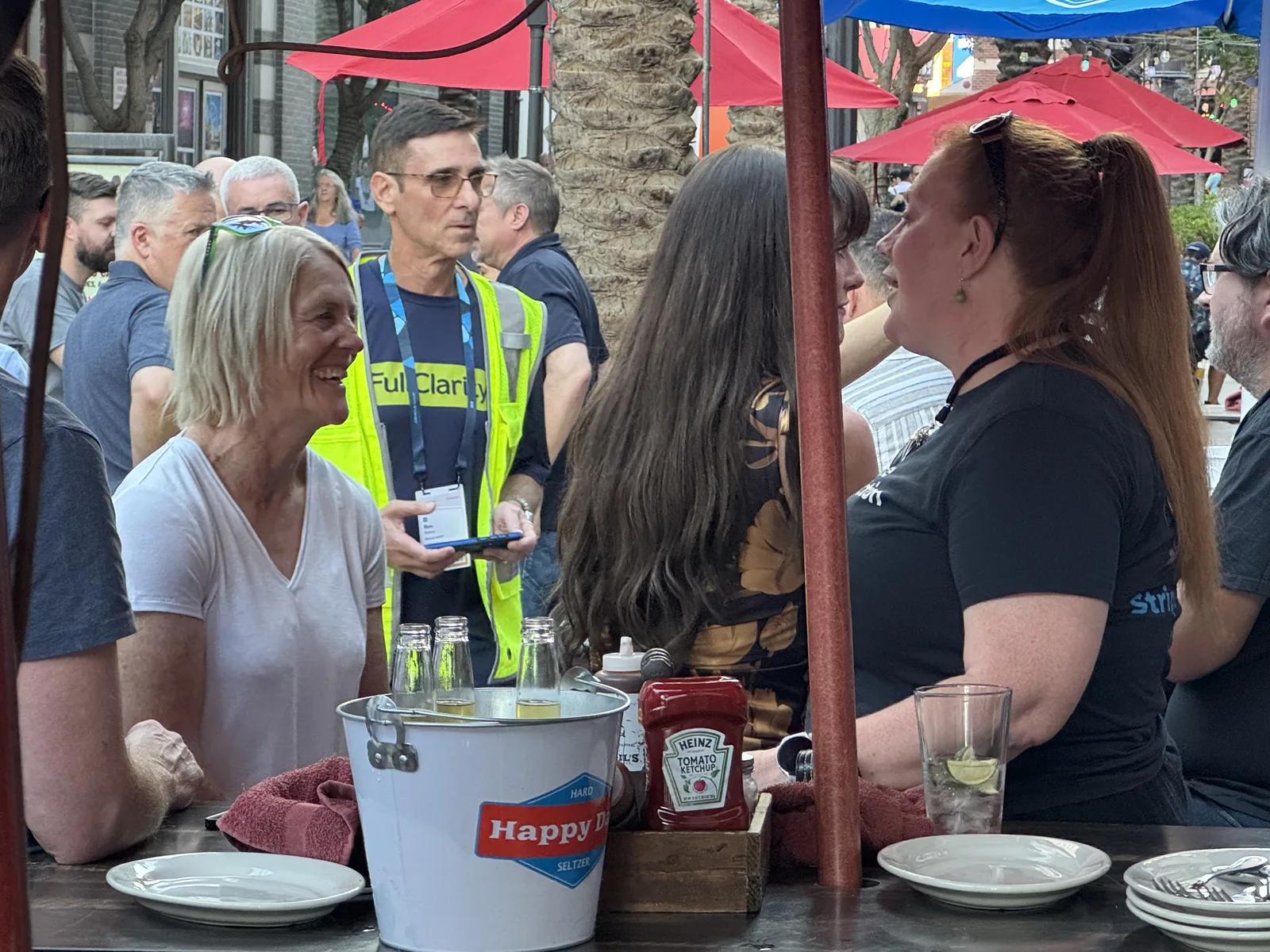 FullClarity team and guests chatting over drinks on the Virgil's patio